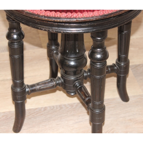 103 - Charles Wadman of Bath - A 19th century ebonised piano stool with red upholstery, height adjustable,... 