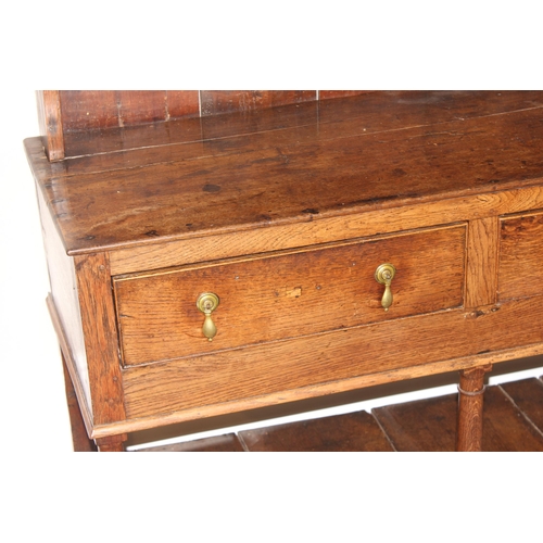 86 - A Georgian oak dresser, the base with 3 drawers with brass drop handles and the top with 3 shelves, ... 