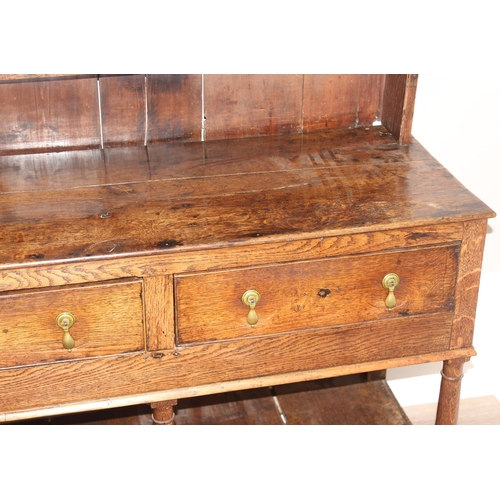 86 - A Georgian oak dresser, the base with 3 drawers with brass drop handles and the top with 3 shelves, ... 