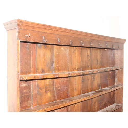 86 - A Georgian oak dresser, the base with 3 drawers with brass drop handles and the top with 3 shelves, ... 