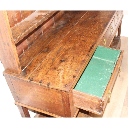 86 - A Georgian oak dresser, the base with 3 drawers with brass drop handles and the top with 3 shelves, ... 