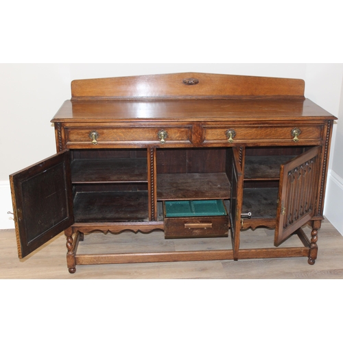 16 - An early 20th century oak sideboard with carved details, approx 151cm wide x 48cm deep x 110cm tall