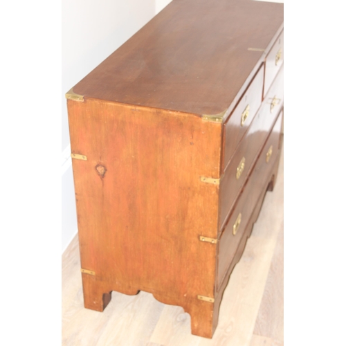 1 - A 19th century mahogany campaign style 2 over 2 chest of drawers, with recessed brass handles and br... 