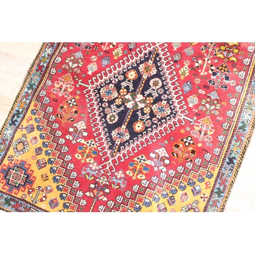 210 - A highly decorative hand made runner rug of red ground, likely Turkish, approx 210cm x 76cm