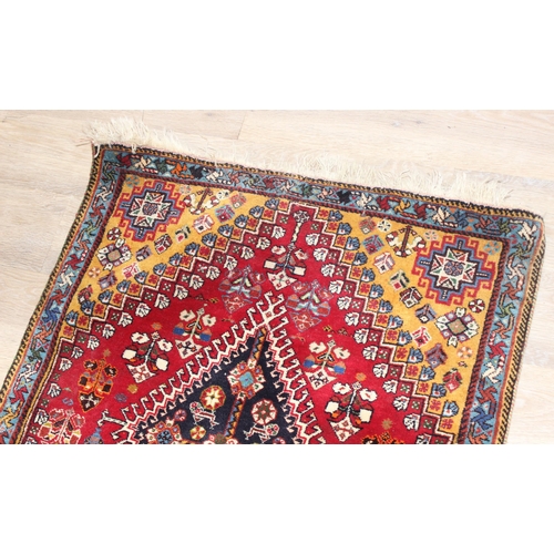 210 - A highly decorative hand made runner rug of red ground, likely Turkish, approx 210cm x 76cm