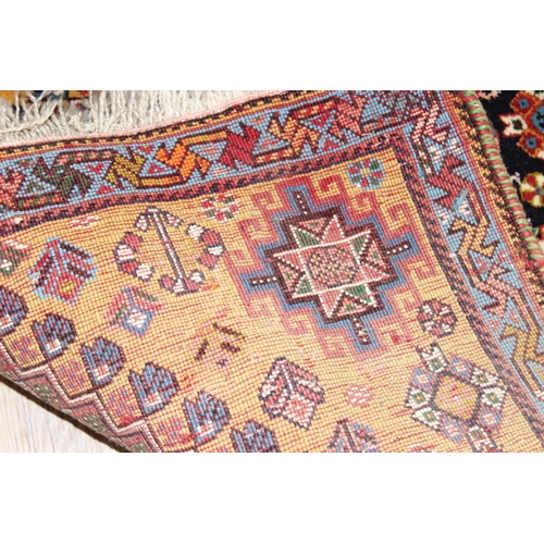 210 - A highly decorative hand made runner rug of red ground, likely Turkish, approx 210cm x 76cm