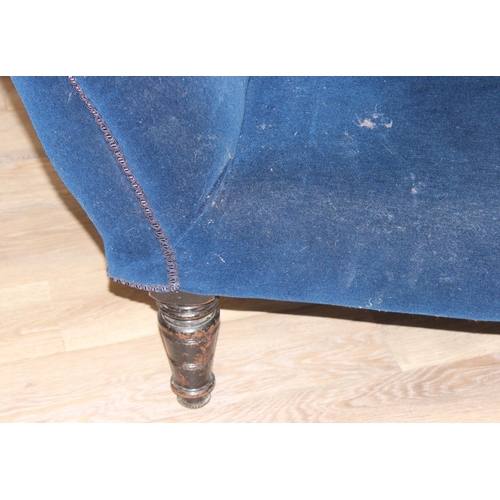 35 - An antique button back chaise longue with navy blue velvet upholstery and wooden legs, approx 165cm ... 