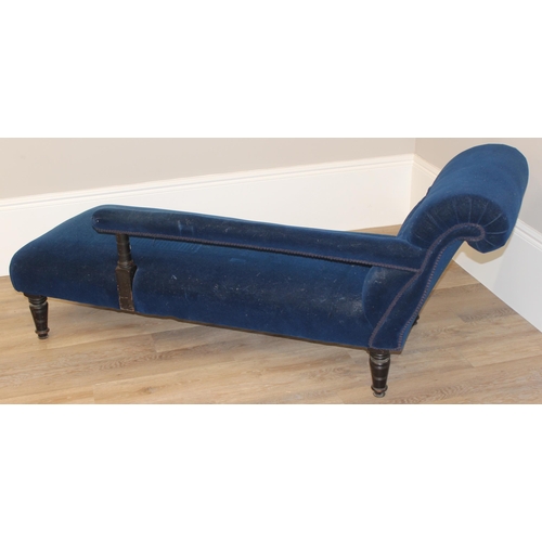 35 - An antique button back chaise longue with navy blue velvet upholstery and wooden legs, approx 165cm ... 