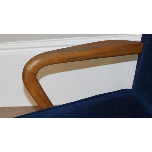 42 - A blue seated retro arm chair with wooden arms, approx 82cm wide x 67cm wide x 81cm tall