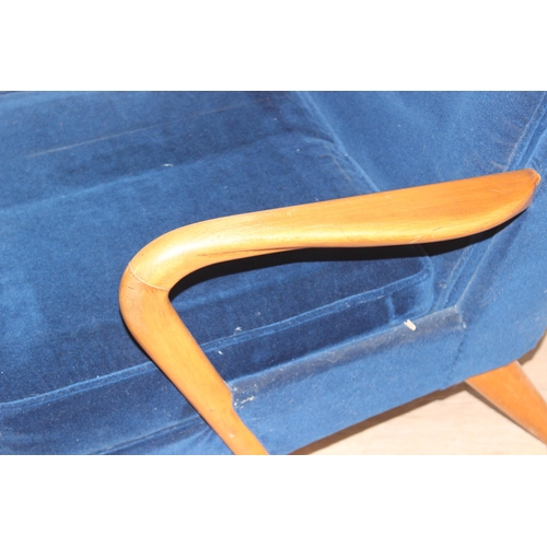 42 - A blue seated retro arm chair with wooden arms, approx 82cm wide x 67cm wide x 81cm tall