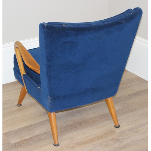 42 - A blue seated retro arm chair with wooden arms, approx 82cm wide x 67cm wide x 81cm tall