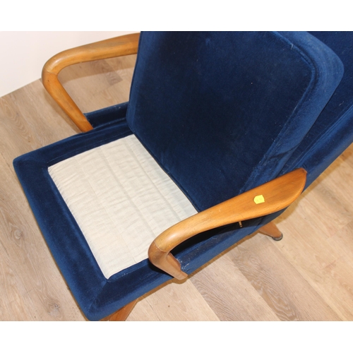 42 - A blue seated retro arm chair with wooden arms, approx 82cm wide x 67cm wide x 81cm tall