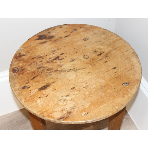 56 - An antique circular topped pine cricket table, approx 52cm diameter x 68cm tall