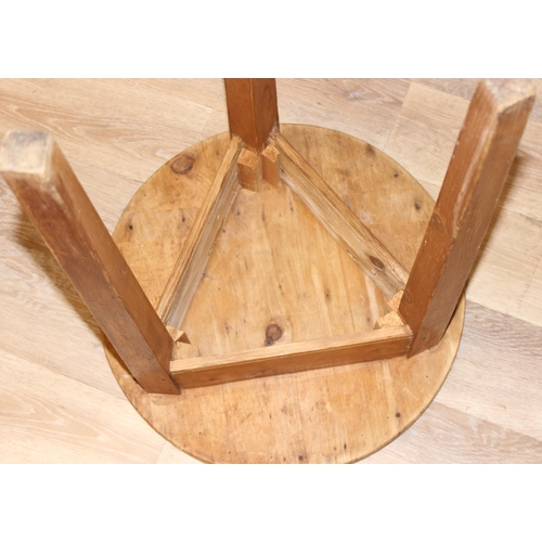 56 - An antique circular topped pine cricket table, approx 52cm diameter x 68cm tall