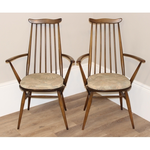 47 - A pair of retro Ercol armchairs, Goldsmith pattern with blue & gold labels, each approx 96cm tall