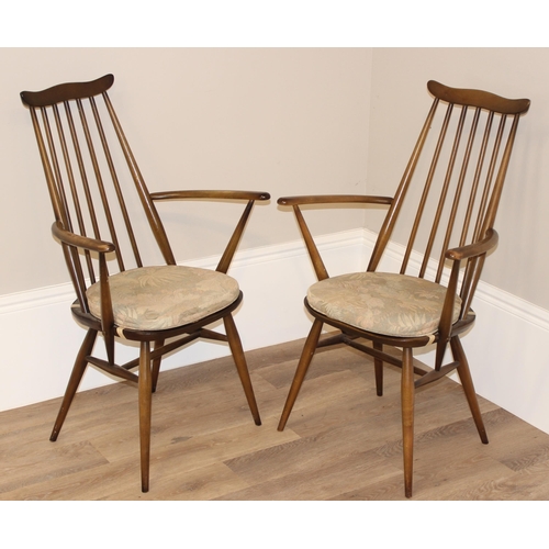 47 - A pair of retro Ercol armchairs, Goldsmith pattern with blue & gold labels, each approx 96cm tall