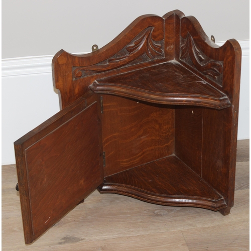 335 - An antique oak corner cabinet with mirrored door and carved details, approx 39cm wide x 30cm deep x ... 