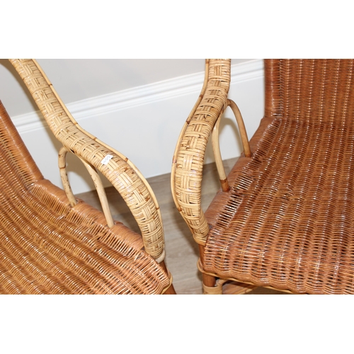 105 - A pair of vintage wicker armchairs, approx 61cm wide x 61cm deep x 68cm tall