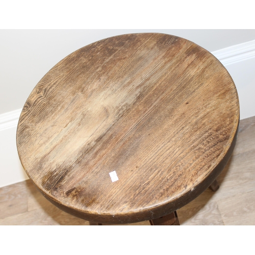 58 - A small vintage circular topped oak side table with 3 legs, approx 46cm wide x 46cm deep x 67cm tall