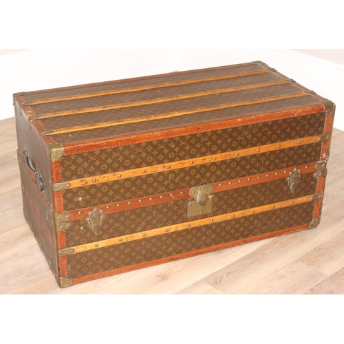 3 - A Louis Vuitton canvas wardrobe trunk, early 20th century, with ash banding, leather edging and deta... 