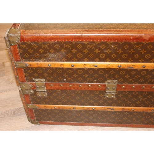 3 - A Louis Vuitton canvas wardrobe trunk, early 20th century, with ash banding, leather edging and deta... 