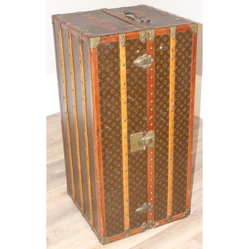 3 - A Louis Vuitton canvas wardrobe trunk, early 20th century, with ash banding, leather edging and deta... 