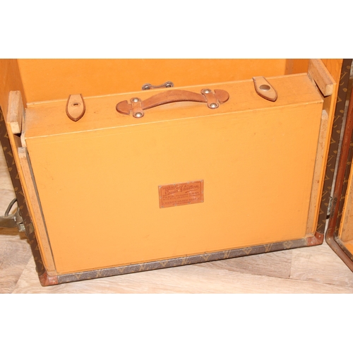 3 - A Louis Vuitton canvas wardrobe trunk, early 20th century, with ash banding, leather edging and deta... 