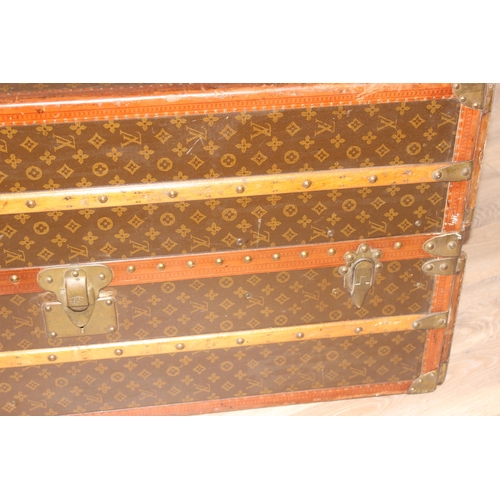 3 - A Louis Vuitton canvas wardrobe trunk, early 20th century, with ash banding, leather edging and deta... 