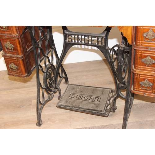 25 - Vintage Singer sewing machine on table with cast iron base, approx 89cm wide x 41cm deep x 105cm tal... 