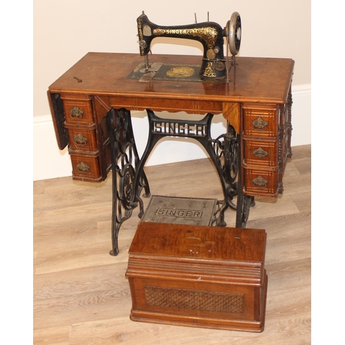 25 - Vintage Singer sewing machine on table with cast iron base, approx 89cm wide x 41cm deep x 105cm tal... 