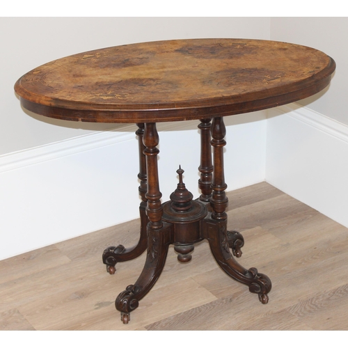 80 - A Victorian oval topped walnut table with decorative pillar base, approx 92cm wide x 57cm deep x 69c... 