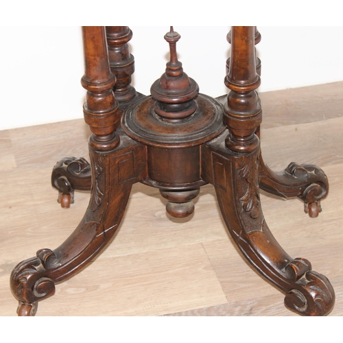 80 - A Victorian oval topped walnut table with decorative pillar base, approx 92cm wide x 57cm deep x 69c... 