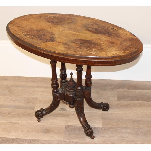 80 - A Victorian oval topped walnut table with decorative pillar base, approx 92cm wide x 57cm deep x 69c... 