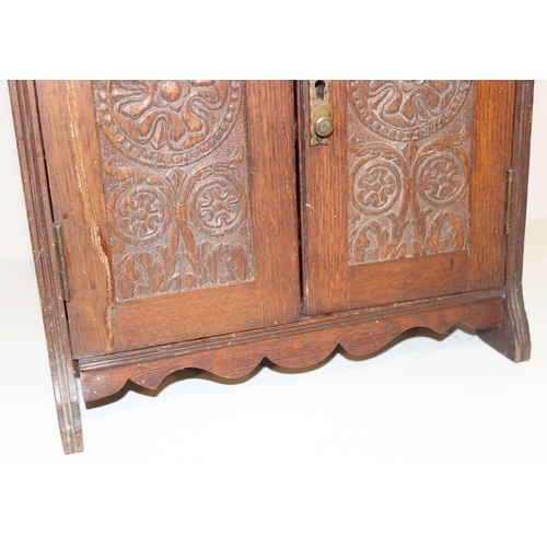 337 - An early 20th century carved oak table top or smoker's cabinet with fitted interior, approx 33cm wid... 