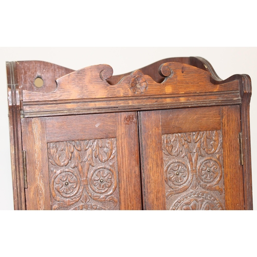 337 - An early 20th century carved oak table top or smoker's cabinet with fitted interior, approx 33cm wid... 