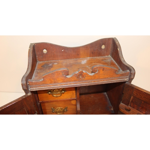 337 - An early 20th century carved oak table top or smoker's cabinet with fitted interior, approx 33cm wid... 