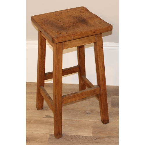 102 - A vintage wooden stool with shaped top, approx 36cm diameter x 68cm tall