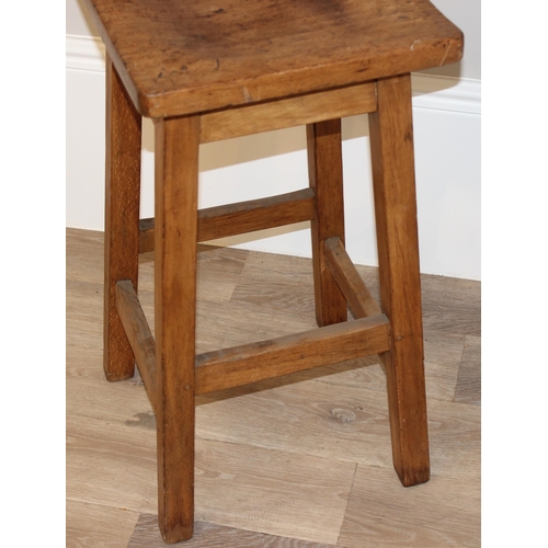 102 - A vintage wooden stool with shaped top, approx 36cm diameter x 68cm tall