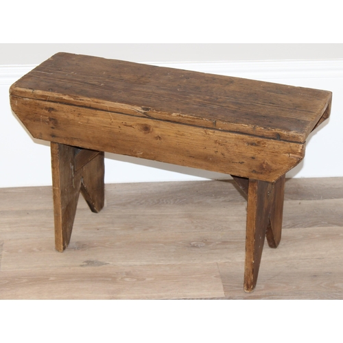 26 - A low rustic pine stool, approx 71cm wide x 26cm deep x 43cm tall