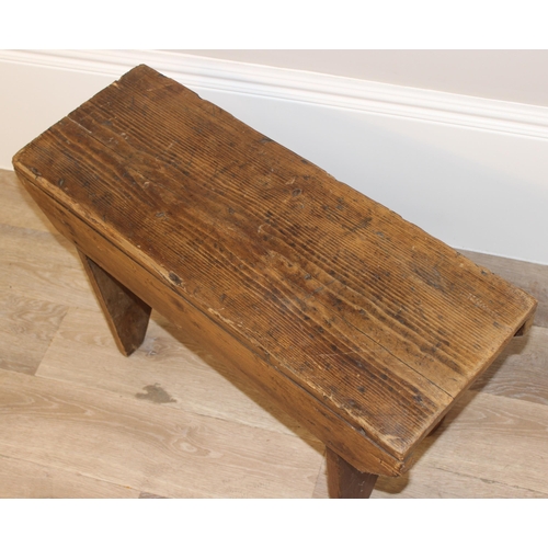 26 - A low rustic pine stool, approx 71cm wide x 26cm deep x 43cm tall