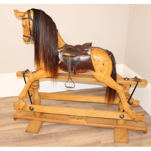 106 - A superb quality modern carved wooden rocking horse, 2007 limited edition number 140/200, with leath... 