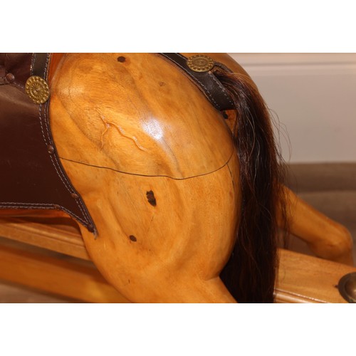 106 - A superb quality modern carved wooden rocking horse, 2007 limited edition number 140/200, with leath... 