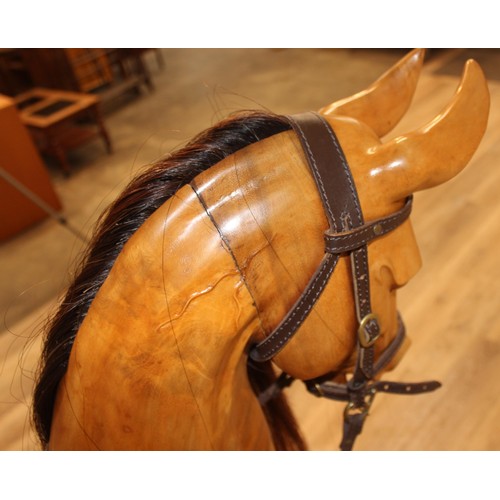 106 - A superb quality modern carved wooden rocking horse, 2007 limited edition number 140/200, with leath... 