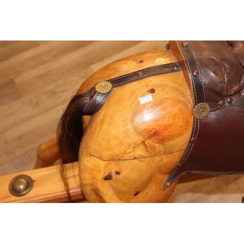 106 - A superb quality modern carved wooden rocking horse, 2007 limited edition number 140/200, with leath... 