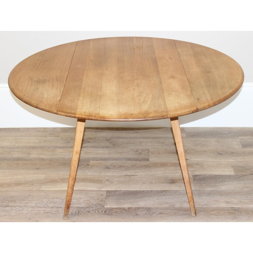 109 - Mid-century oval shaped Ercol drop-leaf kitchen table, with blue & gold Ercol label, approx 113cm W ... 