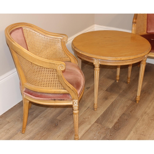 129 - Pair of lightwood carved tub chairs with bergere sides and pink upholstery with matching table, (tab... 