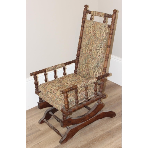 130 - Antique American rocking chair with patterned upholstery, approx 105cm H