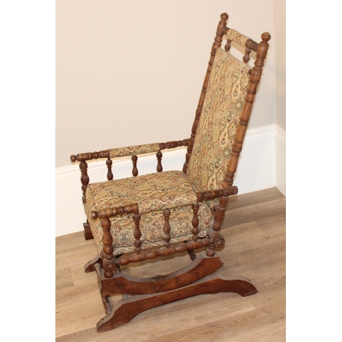 130 - Antique American rocking chair with patterned upholstery, approx 105cm H