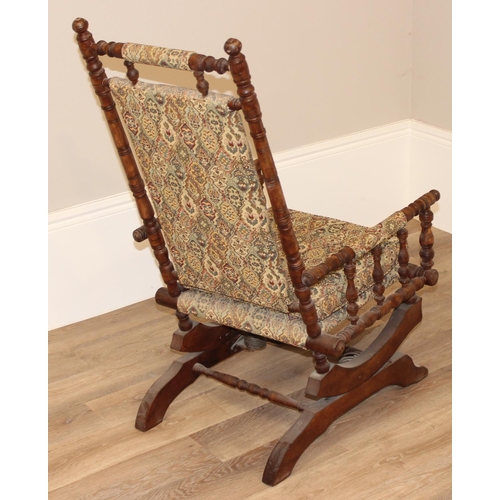 130 - Antique American rocking chair with patterned upholstery, approx 105cm H