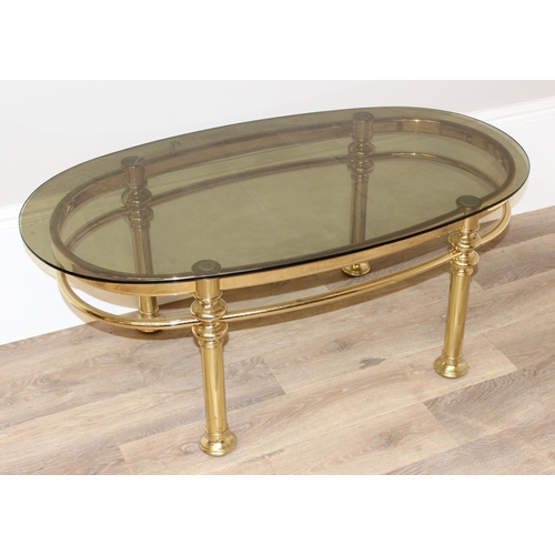 132 - A retro gilt metal and smoked glass topped coffee table, approx 111cm wide x 60cm deep x 45cm tall